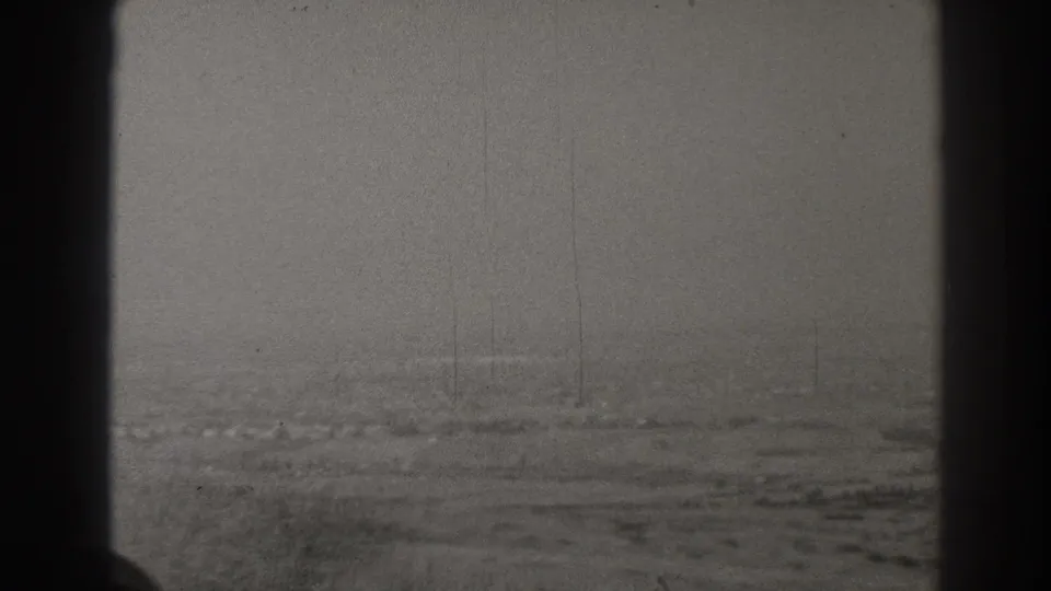 Foggy 1937 aerial view near Long Beach, showing open land, indistinct roads, and aircraft window edges with visible film wear.