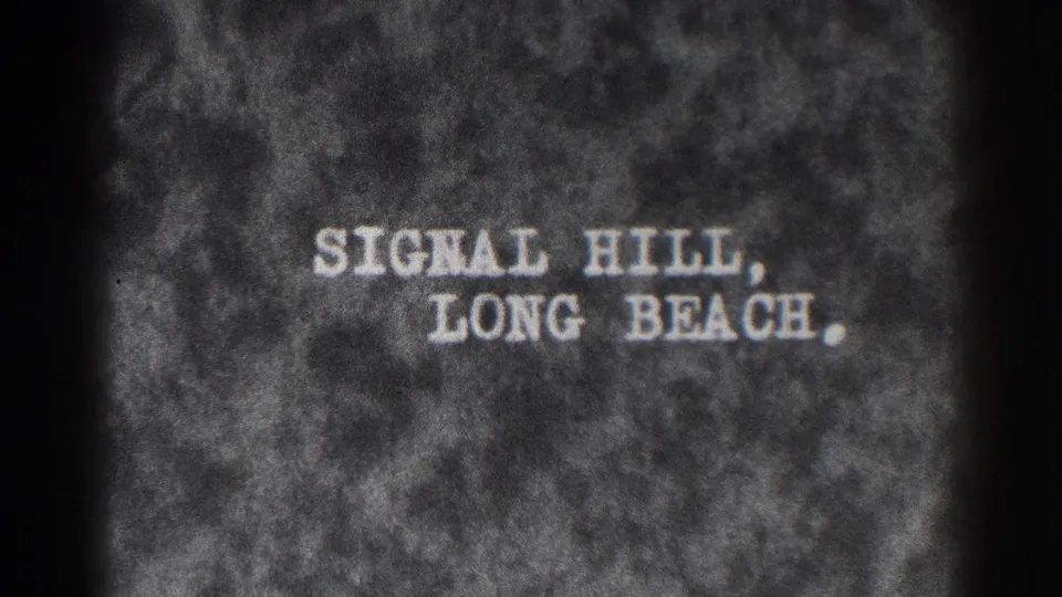 Black-and-white 8mm title card reading Signal Hill, Long Beach, identifying the location of the home-movie scene.