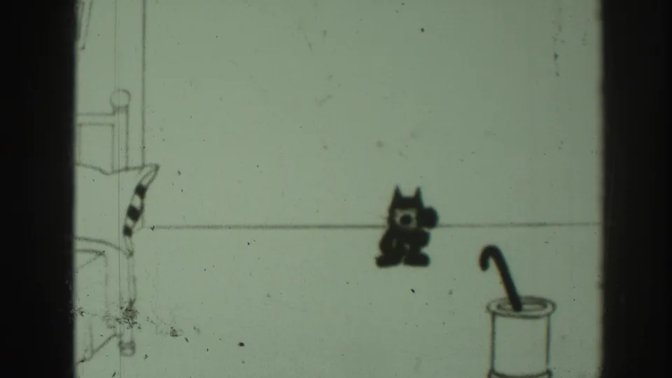 The final 1937 8mm cartoon frame leaves the black cat standing alone near a pail and cane or umbrella in the simple interior.