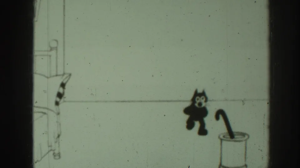 The black cartoon cat pauses near the umbrella stand, with a simple bed or chair edge drawn at the left of the frame.