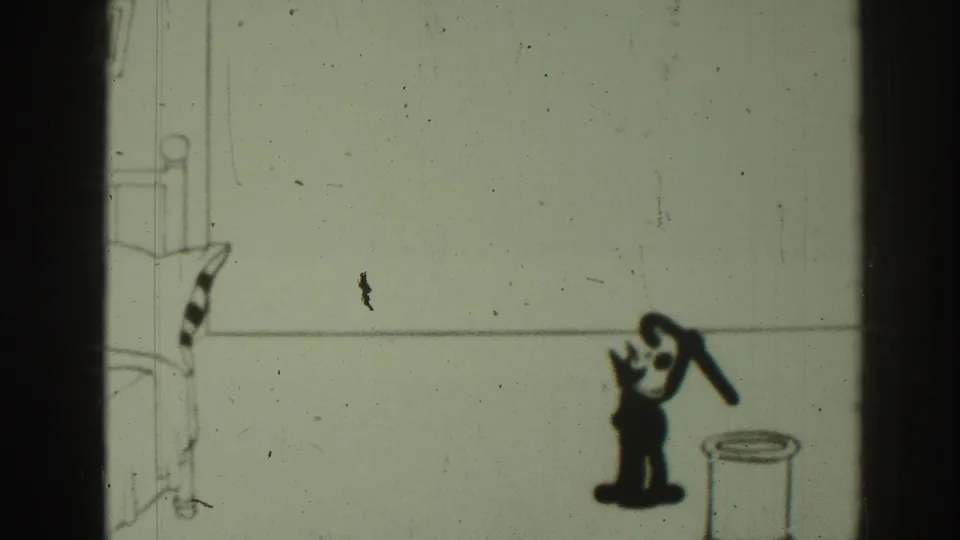 The animated cat appears to pull the umbrella upward from the stand in the sparse 1937 8mm cartoon frame.