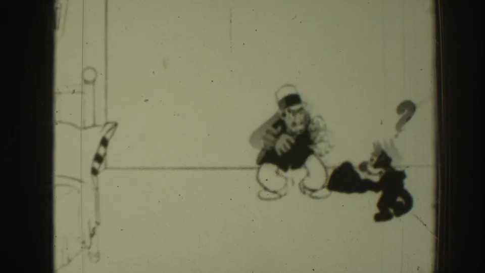 1937 8mm frame of a line-drawn cartoon man in a hat facing a black cat, with a question mark and visible film wear.