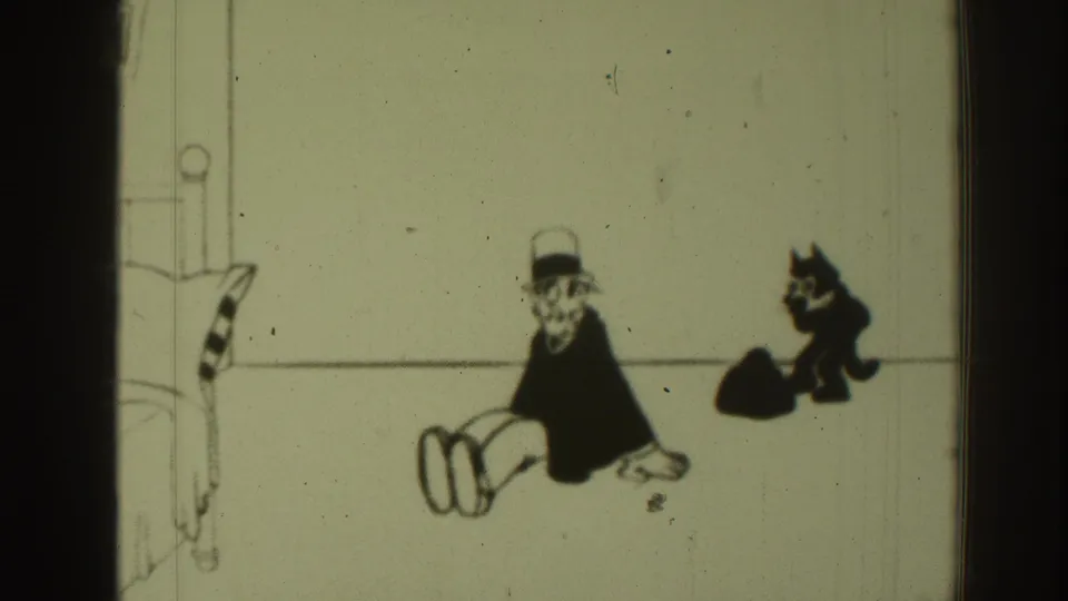 Aged 8mm cartoon frame with a seated man in a hat and a black cat behind him against sparse line-drawn scenery.