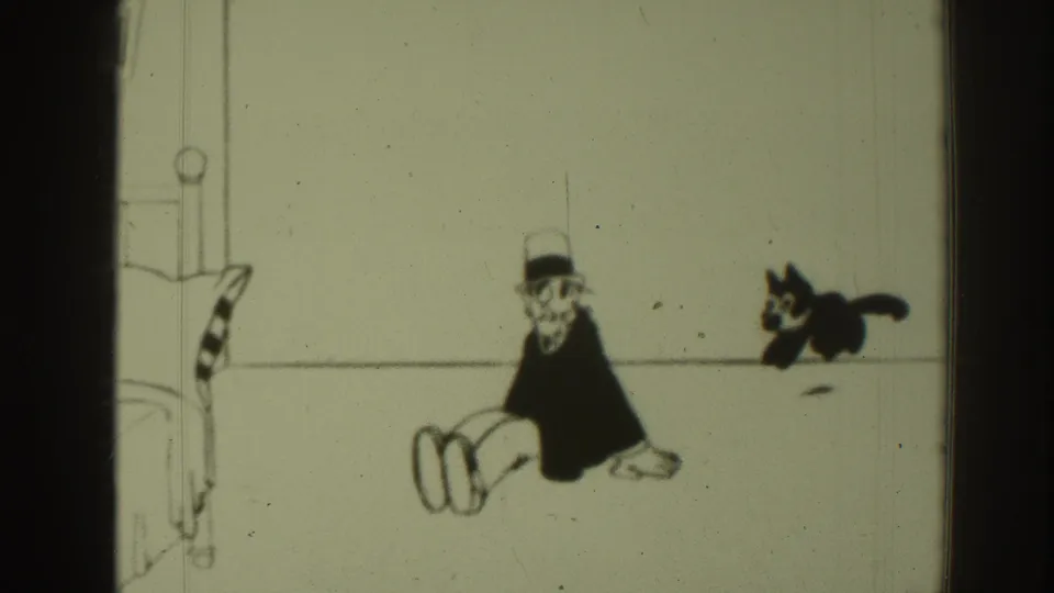 1937 8mm frame from Sacramento metadata showing Felix the Cat jumping near a seated top-hatted cartoon man in a minimal line-drawn room.