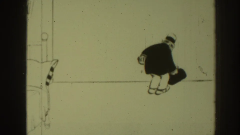 1937 8mm frame showing the top-hatted cartoon figure turned away with a dark bag against a minimal black-and-white background.
