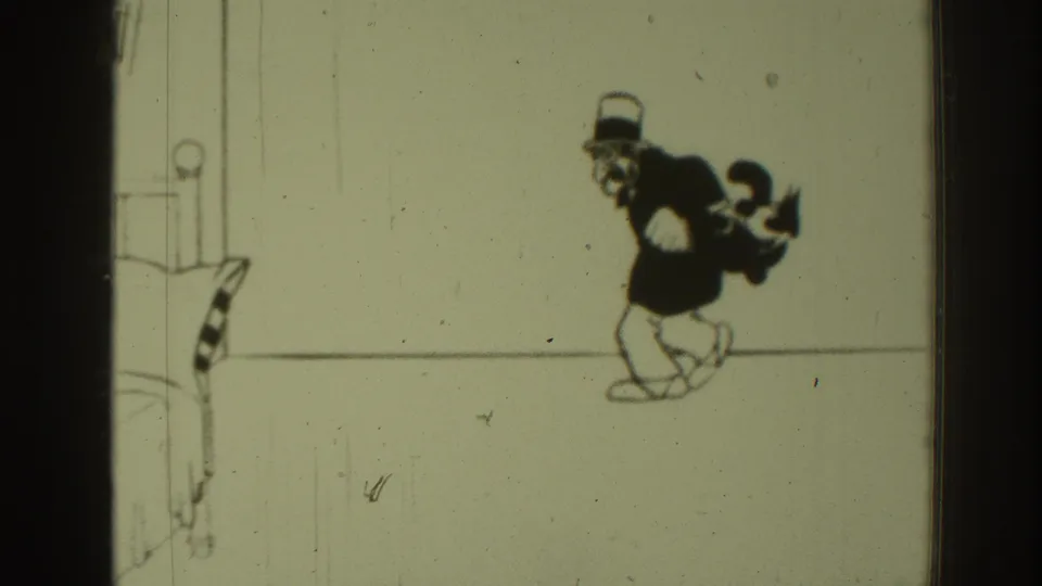 1937 8mm frame of the cartoon figure walking as a smaller cat-like character appears behind him in the sparse animated scene.