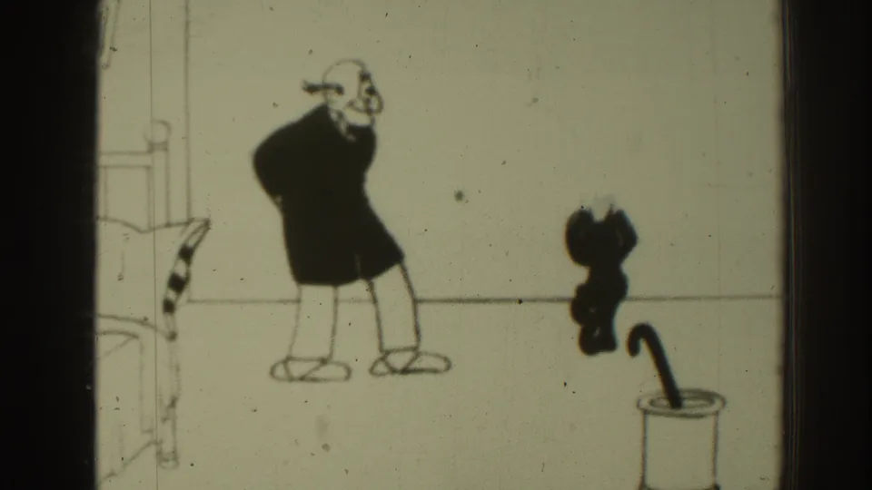 1937 8mm frame from a Felix the Cat animated scene, with Felix emerging near a container while a stooped man reacts in a simple room.