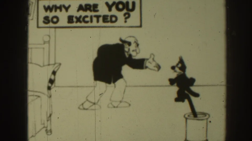 1937 8mm cartoon frame with Felix facing a bent-over man under the visible question text in a sparse drawn room.