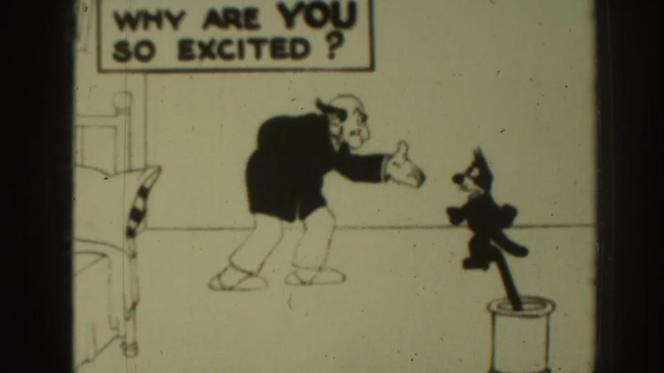 1937 8mm Felix the Cat animation frame showing Felix near a cylindrical container as a stooped man gestures toward him.