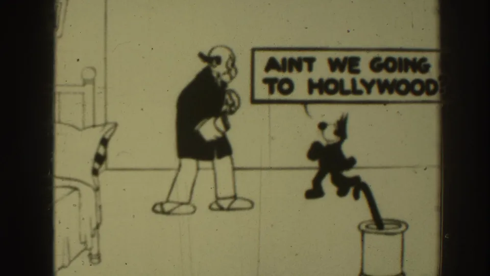 1937 Sacramento 8mm frame showing a cartoon cat addressing a balding man in a drawn bedroom with a speech bubble about Hollywood.