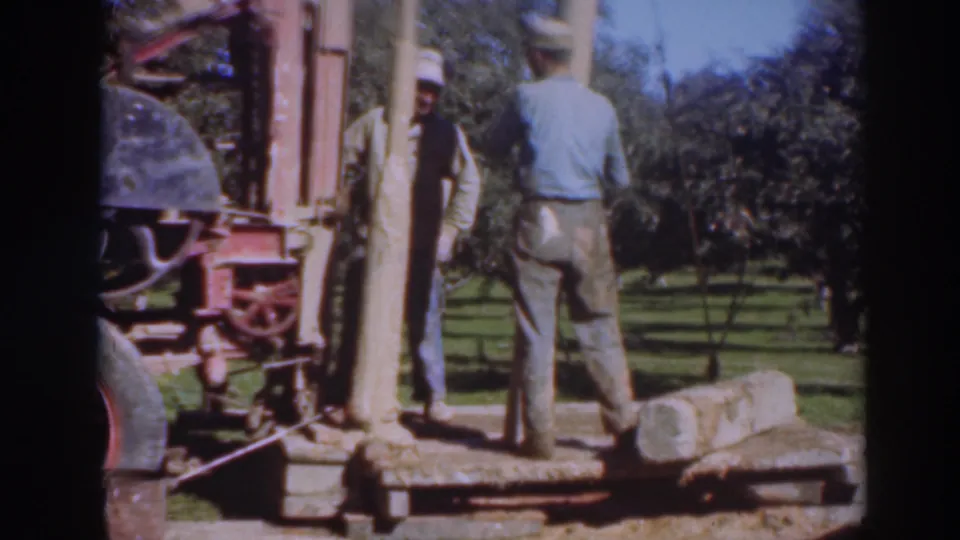 The 1937 Sacramento orchard footage shows two men beside a portable saw rig, a large log, and rough timber under bright daylight.