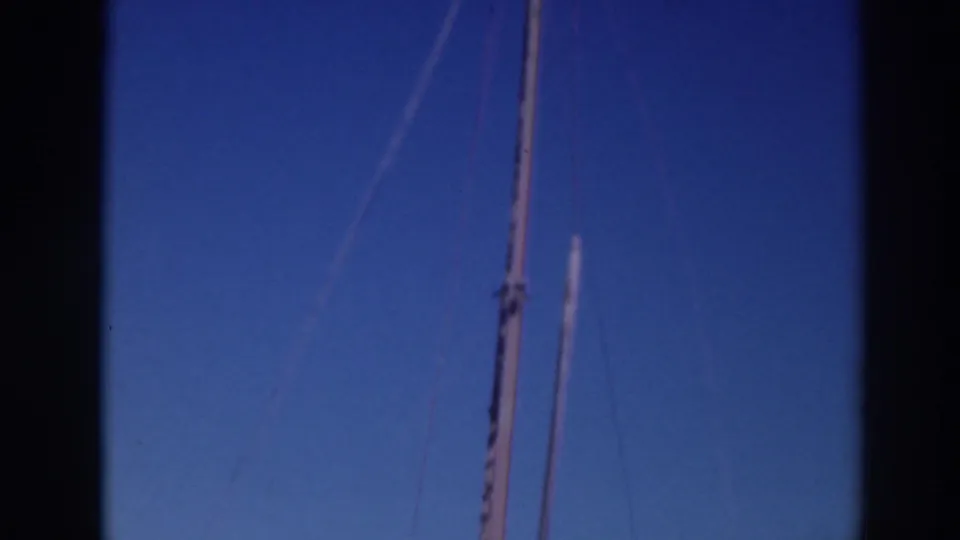 1937 Sacramento home-movie frame showing a tall boat mast or pole with rigging lines against a blue sky.