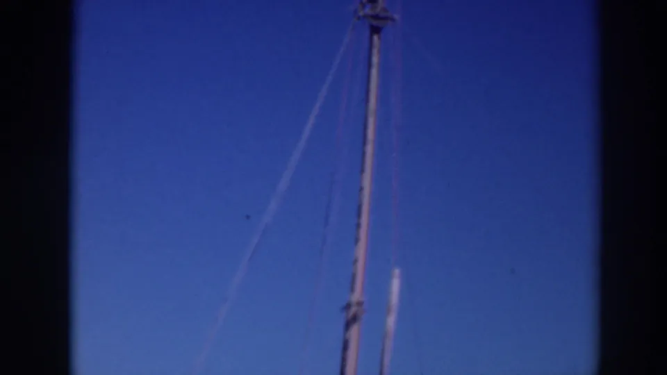 1937 Sacramento footage frame with the upper section of a boat mast and several rigging lines visible against the sky.