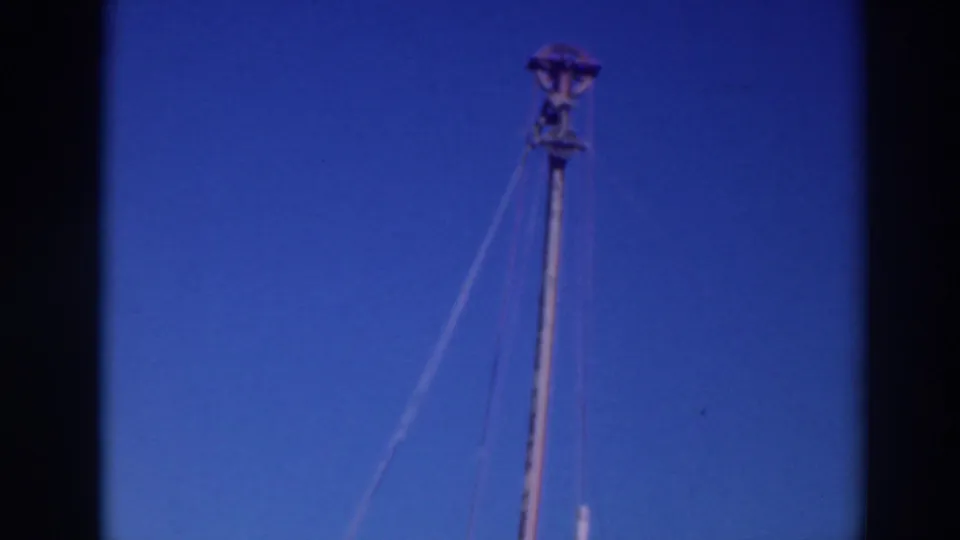 1937 Sacramento frame showing the mast or pole nearly upright, with rigging lines and a second spar visible against the sky.