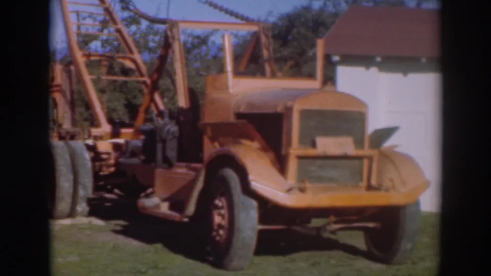 The final frame holds on the orange truck rear and crane boom in the 1937 Sacramento yard scene.