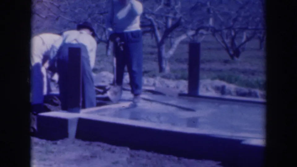 The final frame shows adults close to the slab and posts, with bare orchard trees stretching behind the rural Sacramento worksite.
