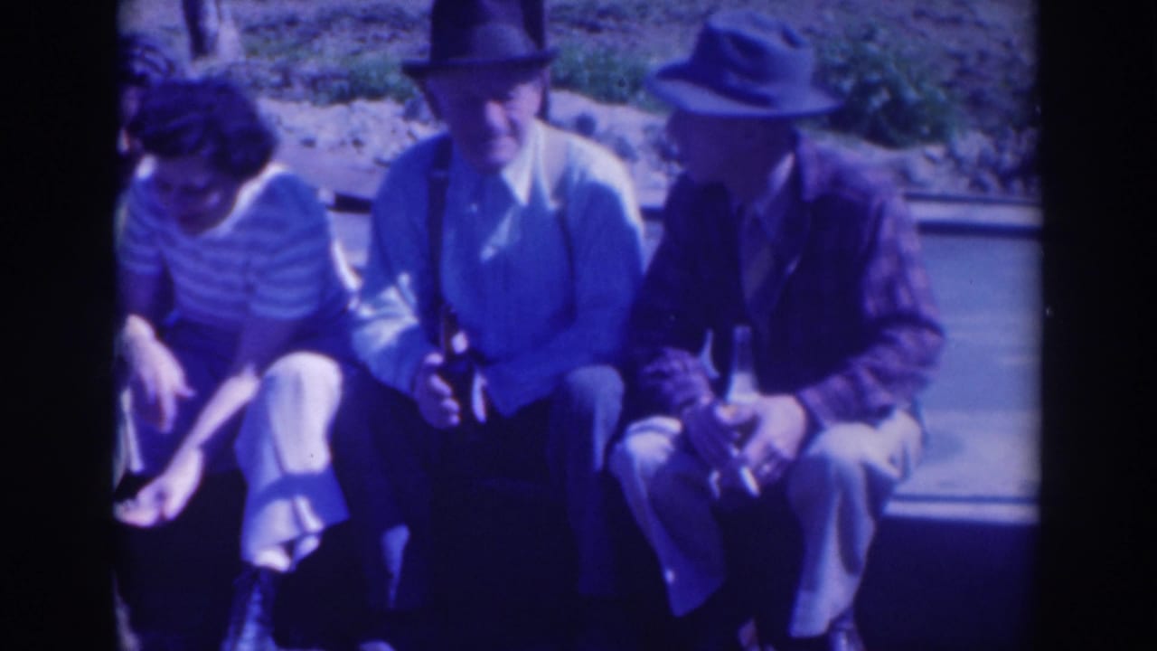 Three adults are centered while a fourth is partly cropped at the left edge.