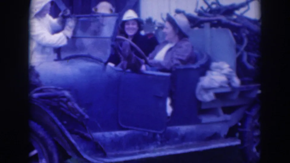 A Sacramento 1937 frame shows women in period hats seated in an open-top automobile, with washing items visible near the rear side.