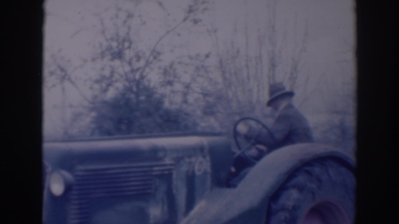 Older man appears to work the tractor controls in a rural Sacramento scene dated 1937 by metadata.