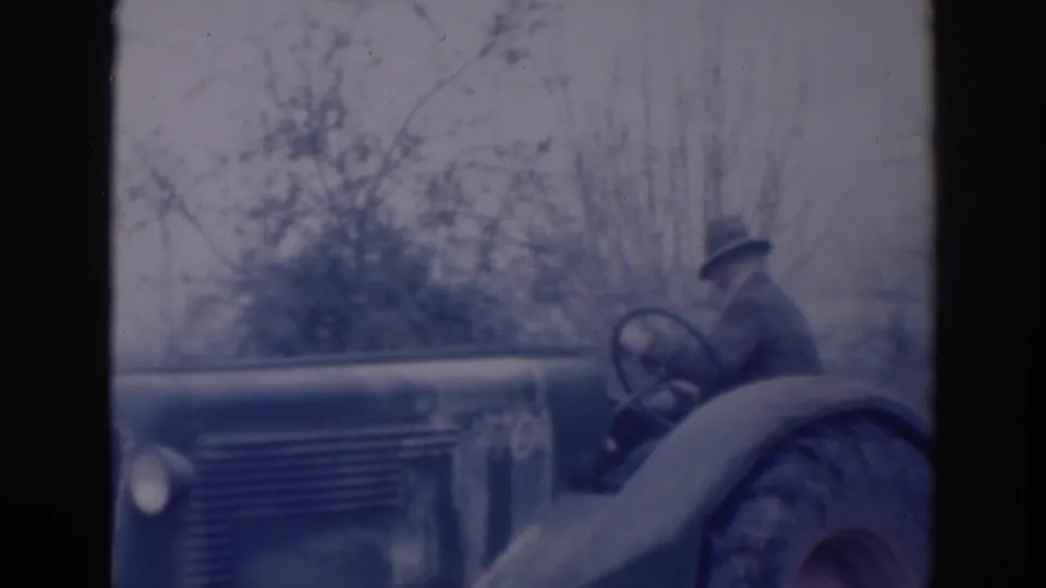 Older man appears to work the tractor controls in a rural Sacramento scene dated 1937 by metadata.