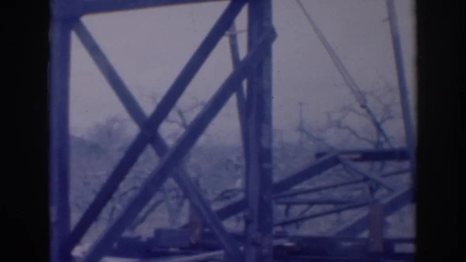 A final view shows the open framework and diagonal supports against bare trees and a pale sky in the 1937 Sacramento footage.