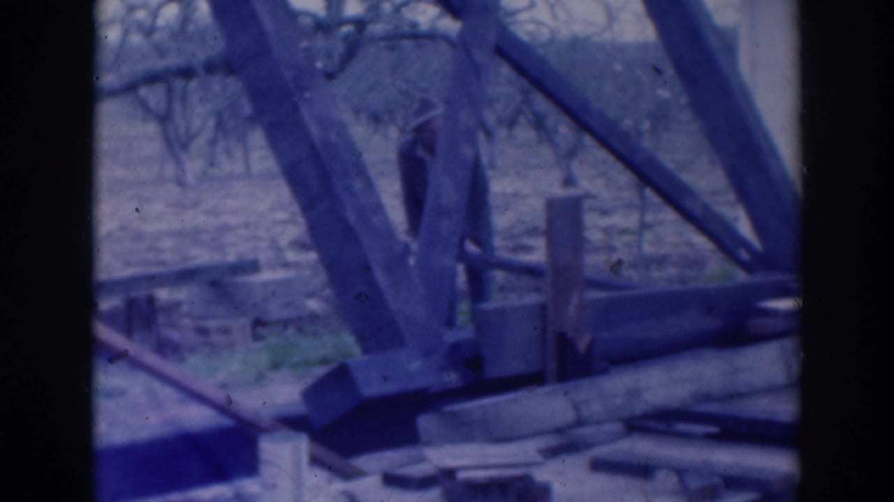 Wooden construction framing and materials seen through a dark 8mm frame edge.