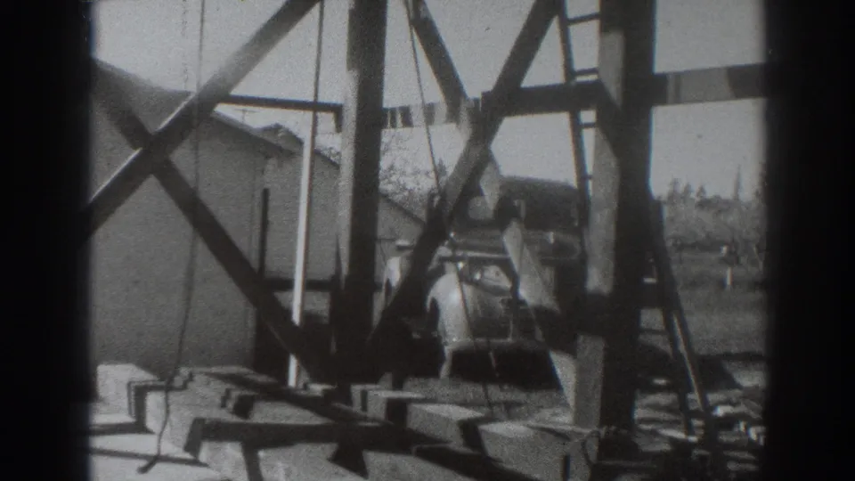 Final frame shows the lower timber rig area, nearby building, hanging cable, ground materials, and open outdoor setting in Sacramento.