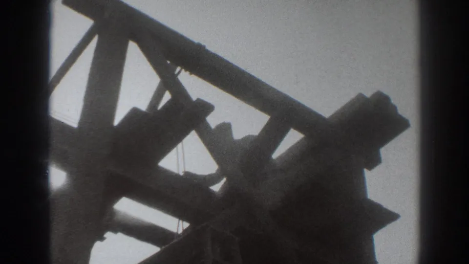 The final frame shows the man silhouetted near the top of the wooden tower structure against a bright sky.
