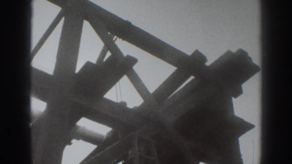 1937 Sacramento construction footage showing silhouetted house framing and braces against an overcast sky.