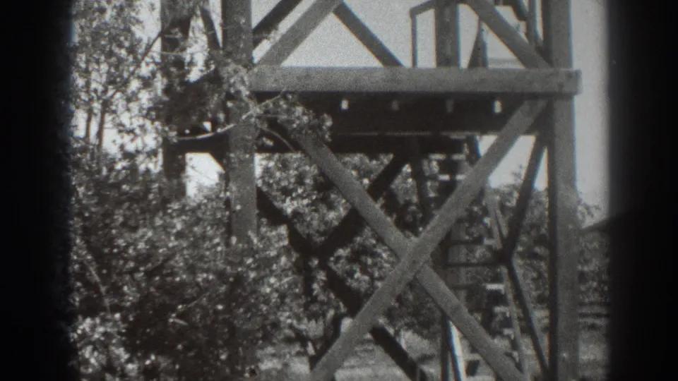 1937 Sacramento 8mm frame showing part of a wooden observation tower, ladder details, trees, and dark film edge borders.