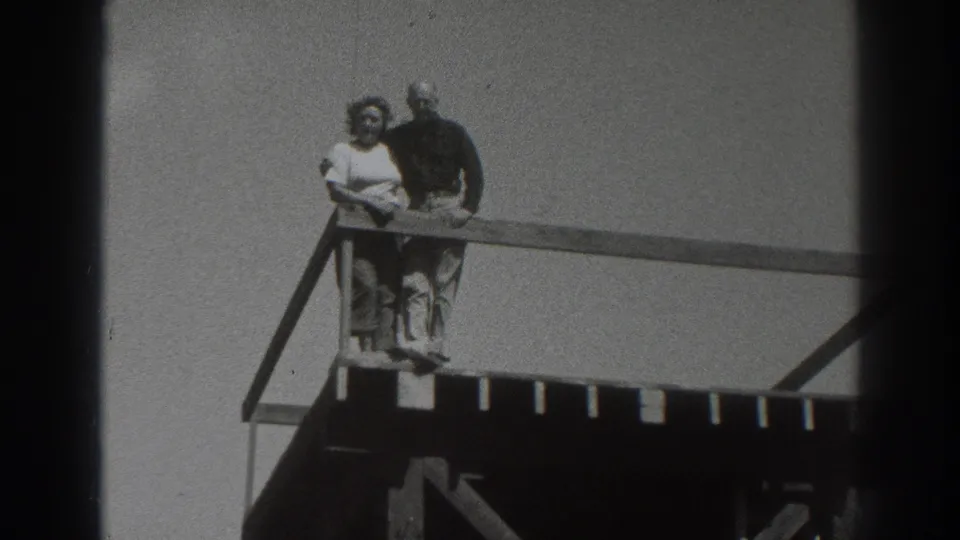 The couple stands close at the railing of an elevated wooden deck, with Sacramento and 1937 supported by the clip metadata.