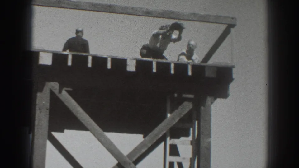 Three figures appear on the Sacramento platform, with one crouched and reaching or lifting an arm during the hat prank.