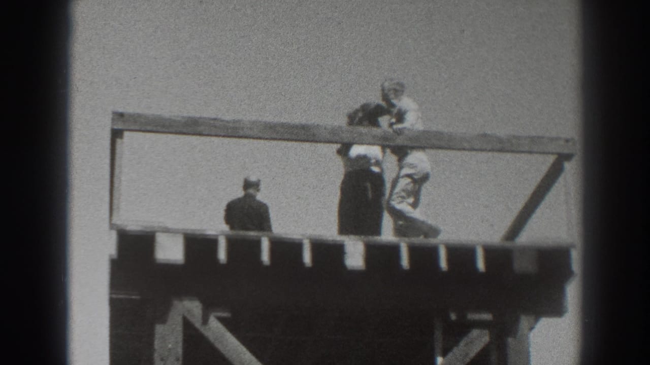 1937 Sacramento footage frame showing people close together at the rail of an elevated wooden platform, with one figure facing away.