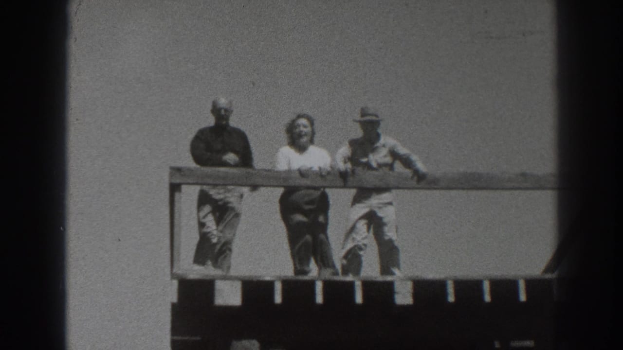 Three adults on a wooden tower platform in Sacramento, California, 1937, with bright sky and distant horizon behind them.
