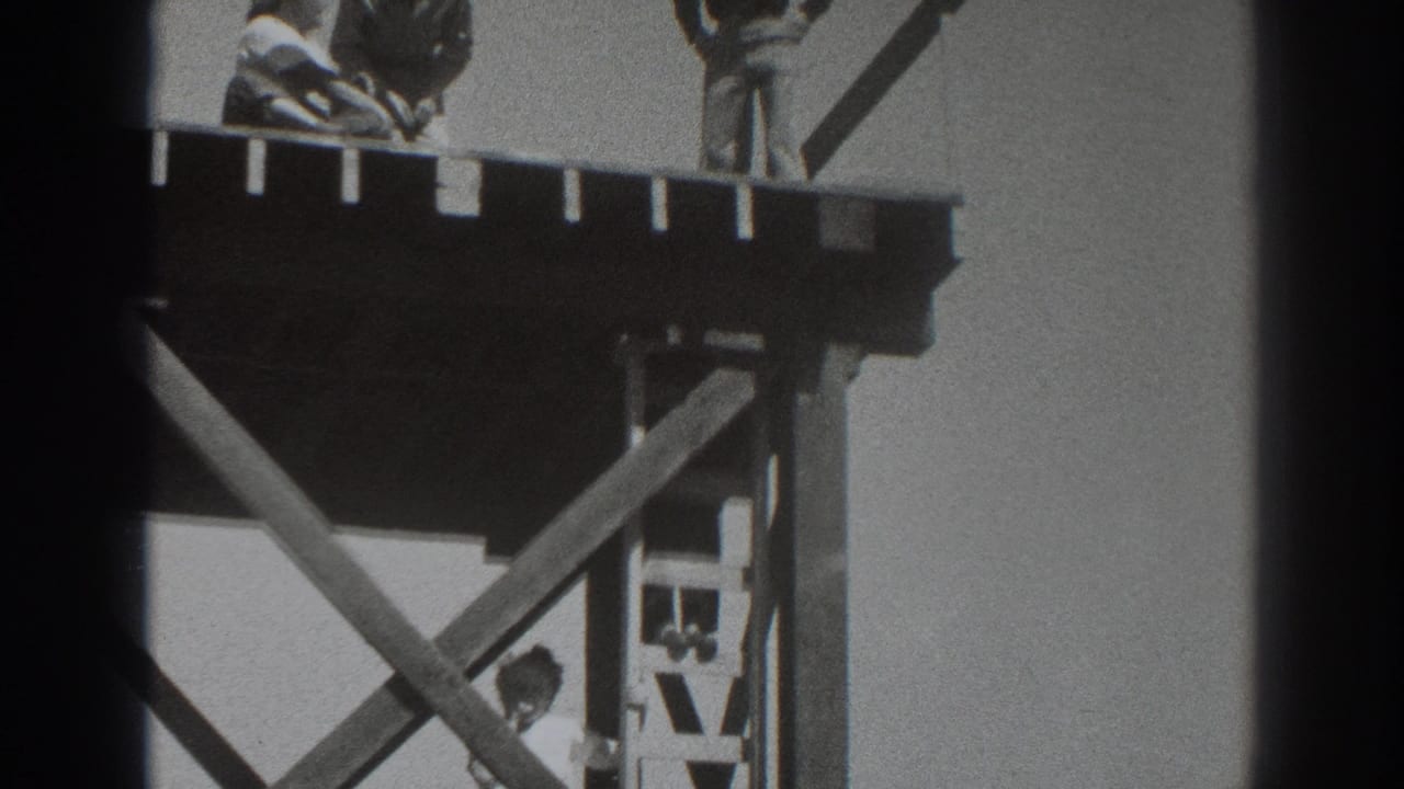 1937 Sacramento frame showing the timber platform from below, with a man near the ladder and two workers cropped along the upper deck.