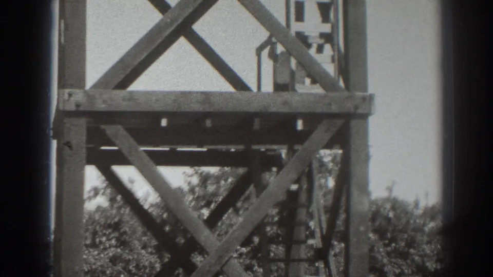 1937 Sacramento frame showing the upper platform of a wooden tower with a small person silhouetted near the railing.