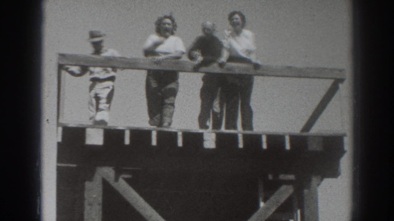 Four adults on the Sacramento overlook platform face the camera and railing, with one hat-wearing figure at the left edge.