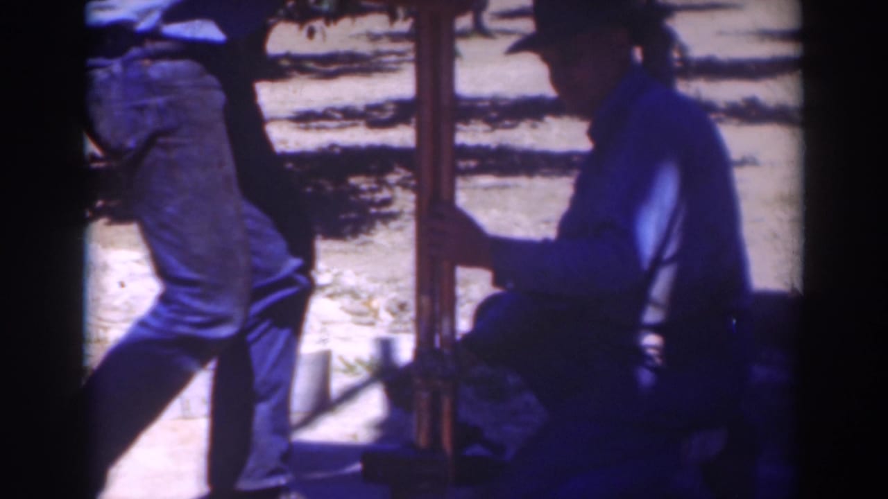 At the end of the 1937 Sacramento clip, one man is partly cropped while another crouches near the upright post in deep shade.