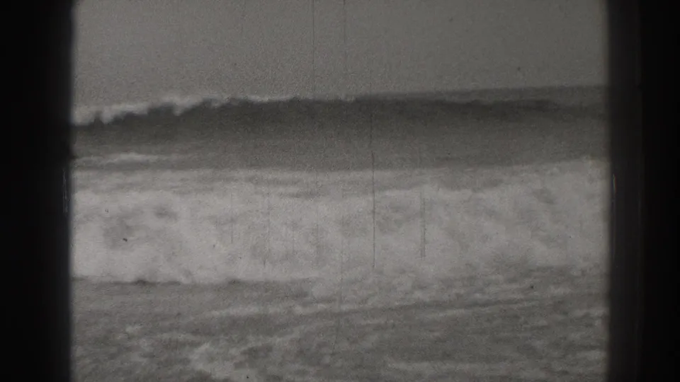 1937 black-and-white 8mm view of Santa Cruz surf breaking below two offshore rock formations.