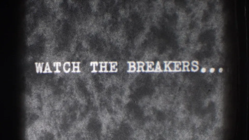 8mm title card from the Santa Cruz clip reading WATCH THE BREAKERS, with visible grain and surface wear.