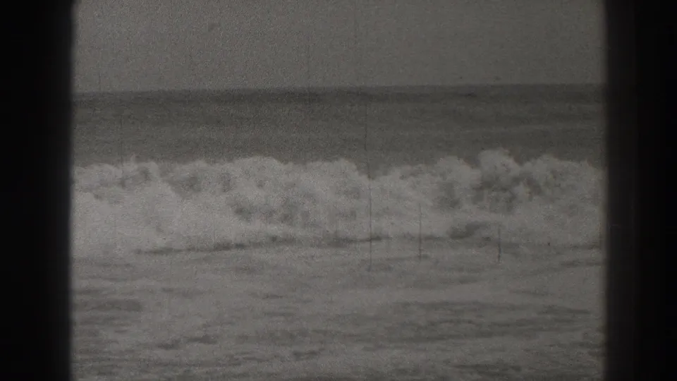 Black-and-white Santa Cruz surf frame from 1937 with a heavy wave collapsing offshore.
