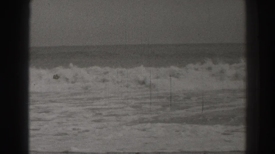 Santa Cruz coastal surf in a 1937 home-movie frame, with foamy waves, a level horizon, and visible 8mm film marks.