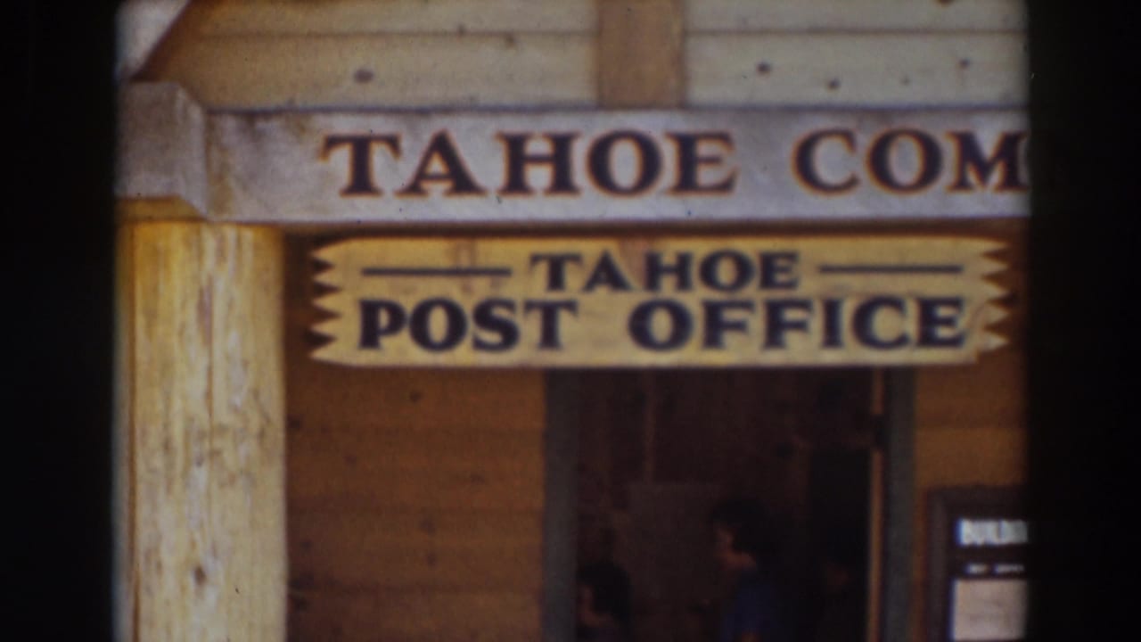Tahoe Post Office sign on a rustic wooden building with doorway below.