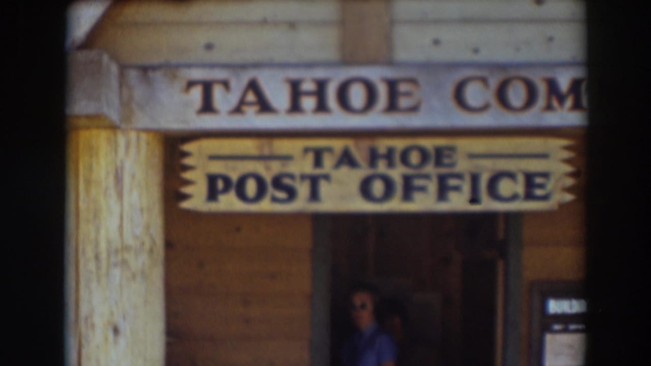 Soft 8mm frame of the Tahoe Post Office exterior in Truckee, with wood walls, sign lettering, and a person partly visible below.