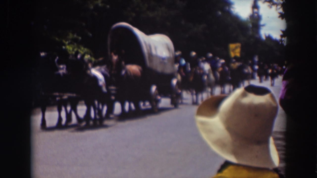 A closer view shows the covered wagon and horses passing the curb during the supplied 1937 Truckee parade footage.