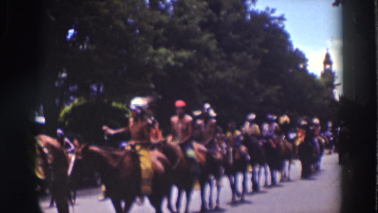 Costumed riders on horses continue through the 1937 Truckee parade, with spectators gathered along the shaded roadside.