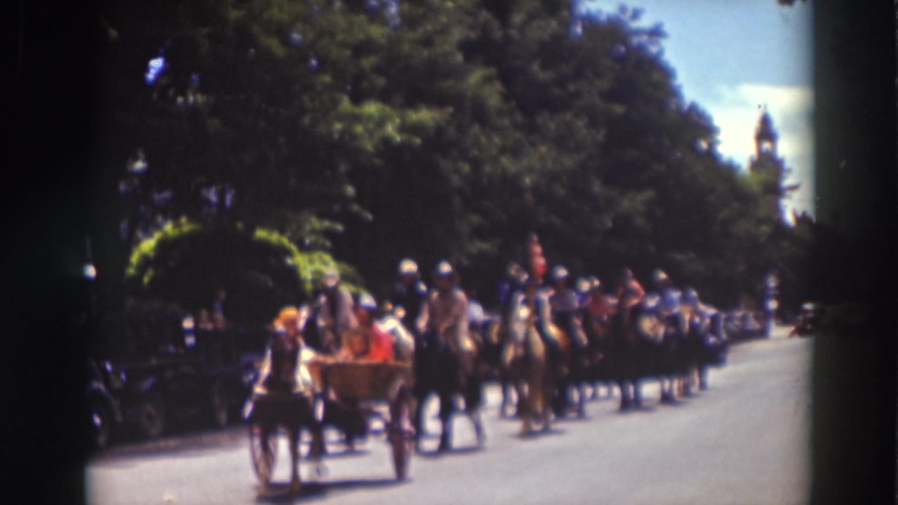 Open buggy with passengers and a horse team passes in front of mounted riders during the 1937 Truckee parade.
