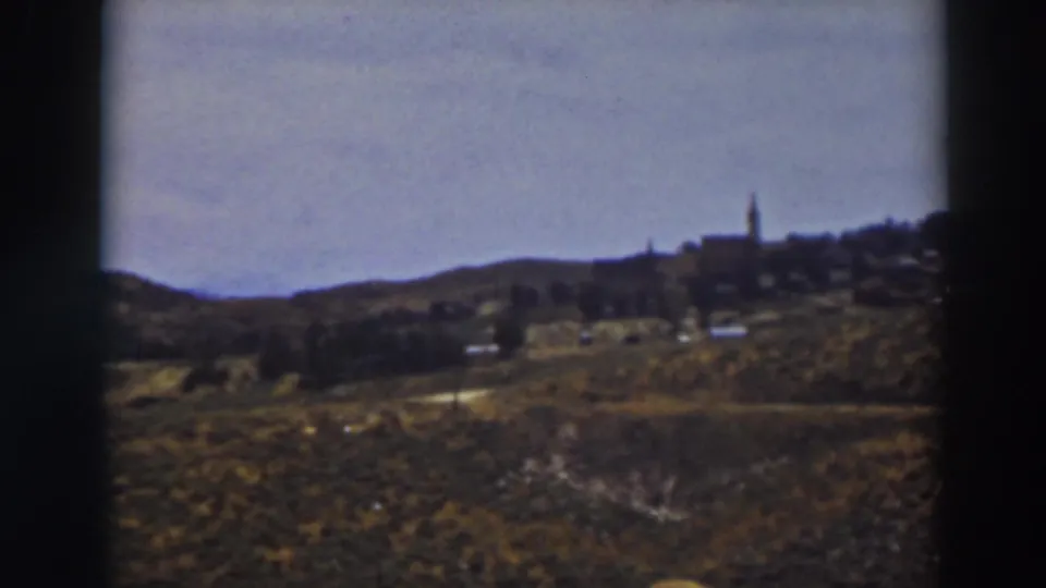 A soft 8mm view across the Truckee countryside toward a small ridge settlement and prominent steeple.