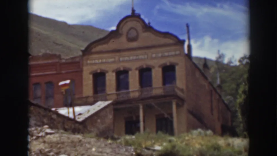Truckee brick building with upper sign lettering and balcony, filmed from a low home-movie angle in 1937.