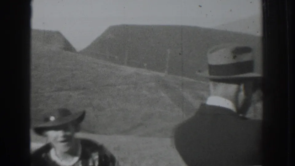 Men in suits and brimmed hats occupy the foreground while rolling hills fill the background in the Vacaville home movie.